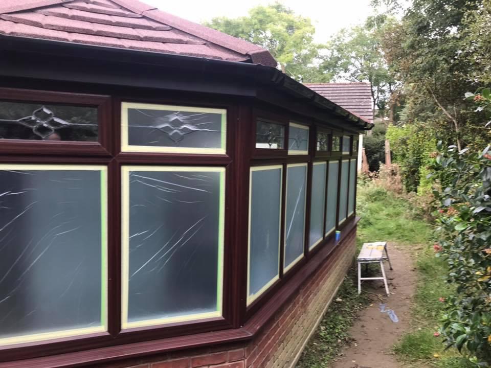 Conservatory windows sprayed in a red UPVC paint colour