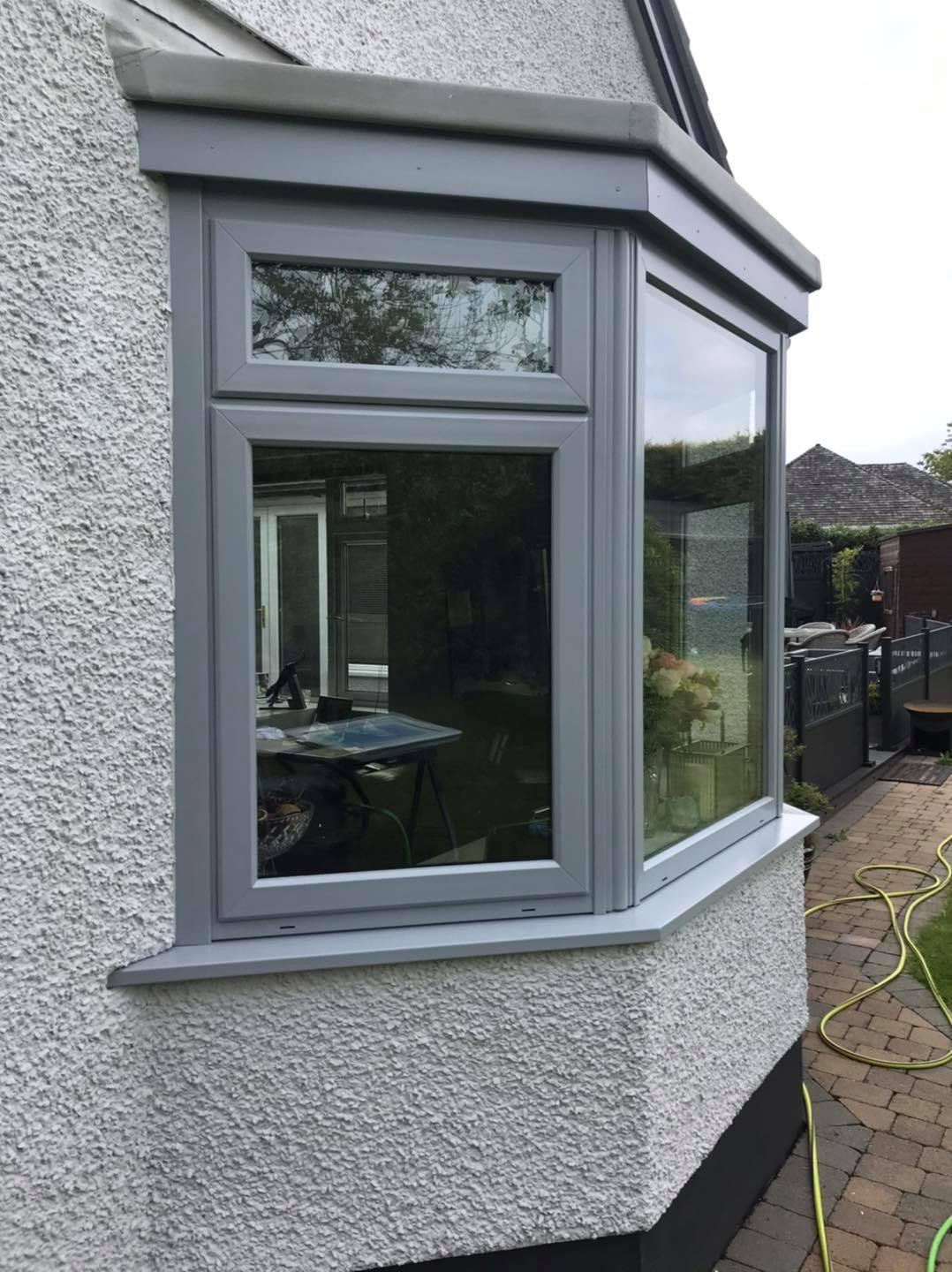 Bay window spray painted in a light grey UPVC colour