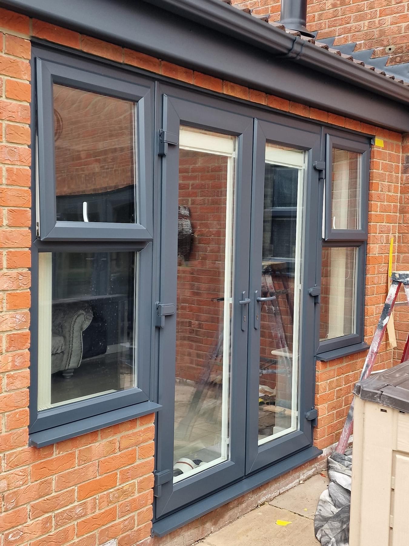 Windows and door spray painted in a grey UPVC colour