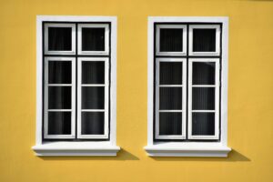 White UPVC windows on a yellow house