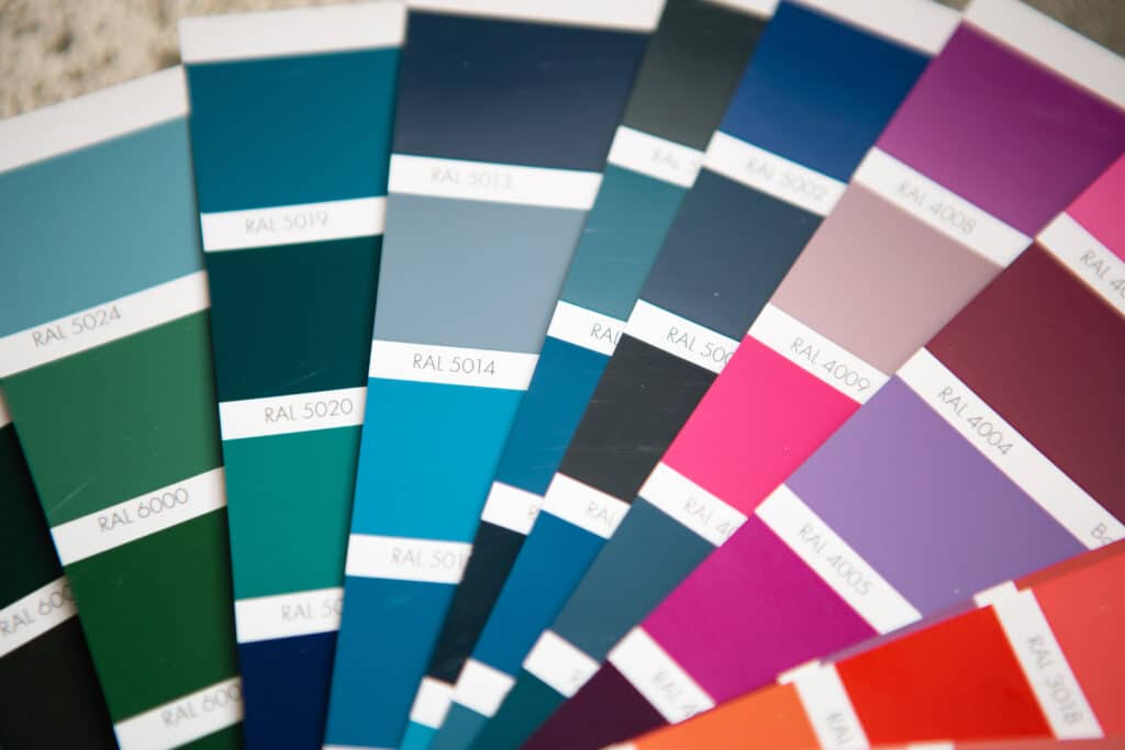Selection of the paint color for decorative home repairs to the palette with layouts. A fan of shades in your hand inside the home. Repair and construction, paint and varnish coating